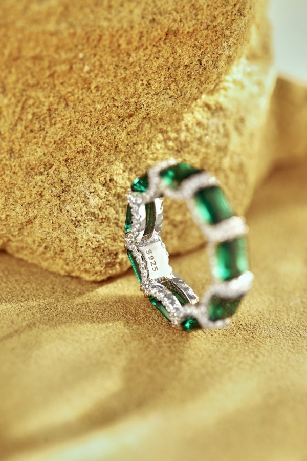 eternity ring, handcrafted in 925 sterling silver set with sparkling green cubic zirconia stones.