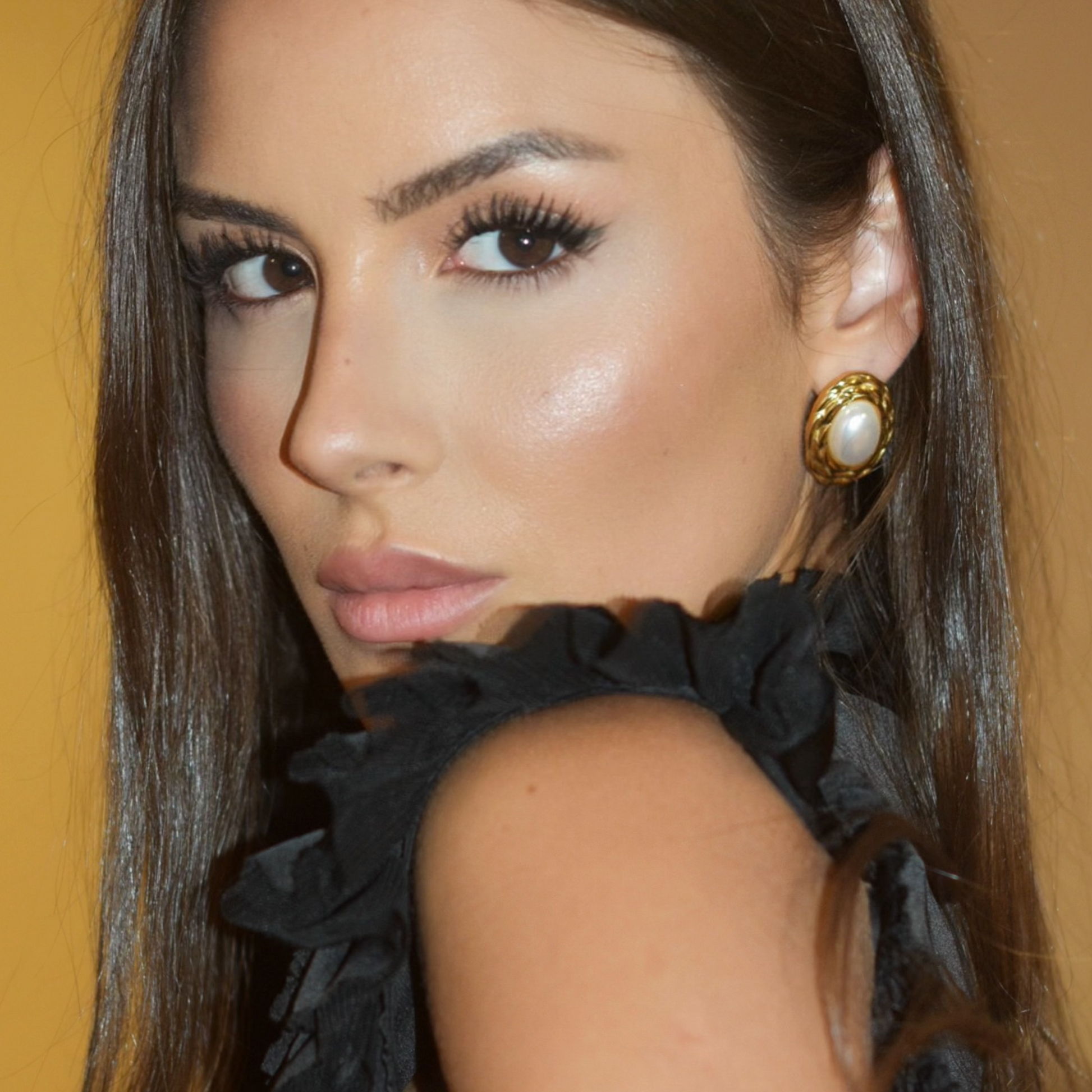 Female model Bia Rebelo de Sousa wearing the elegant vintage pearl earrings in gold plating, handcrafted by Lucky 13 Jewelry