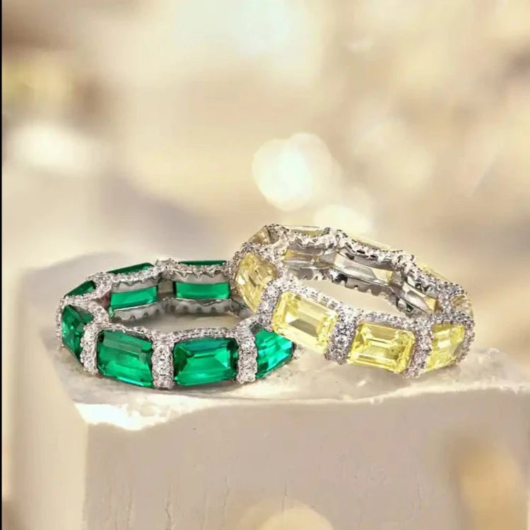 2 eternity rings, set with sparkling emerald cut zirconia stones.