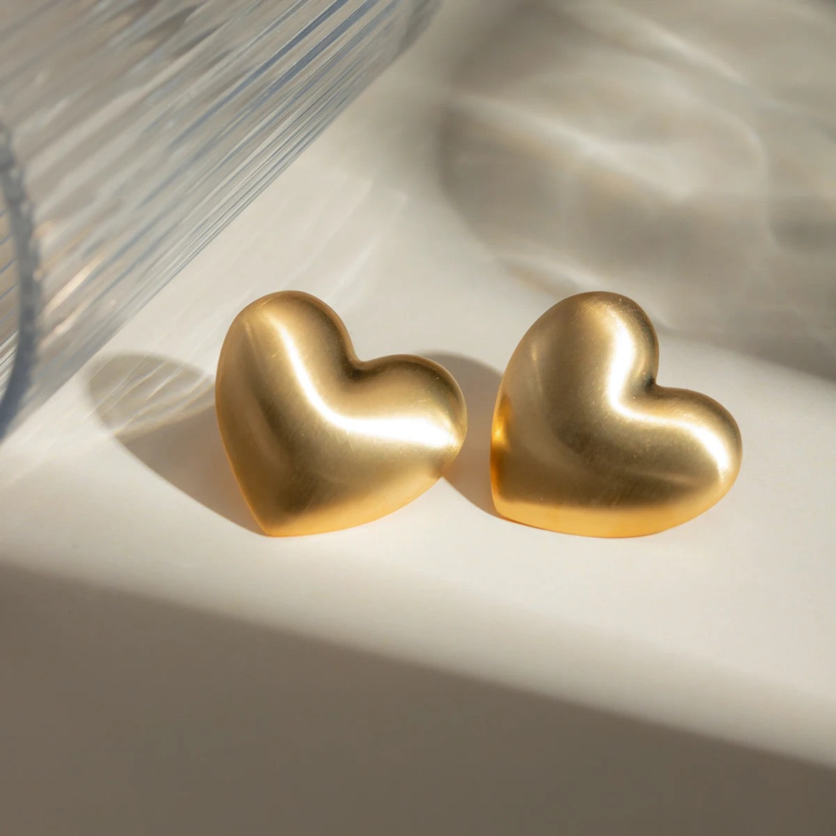 Vintage gold heart shaped earrings handcrafted in stainless steel with brushed gold finish, by Lucky 13 jewelry.