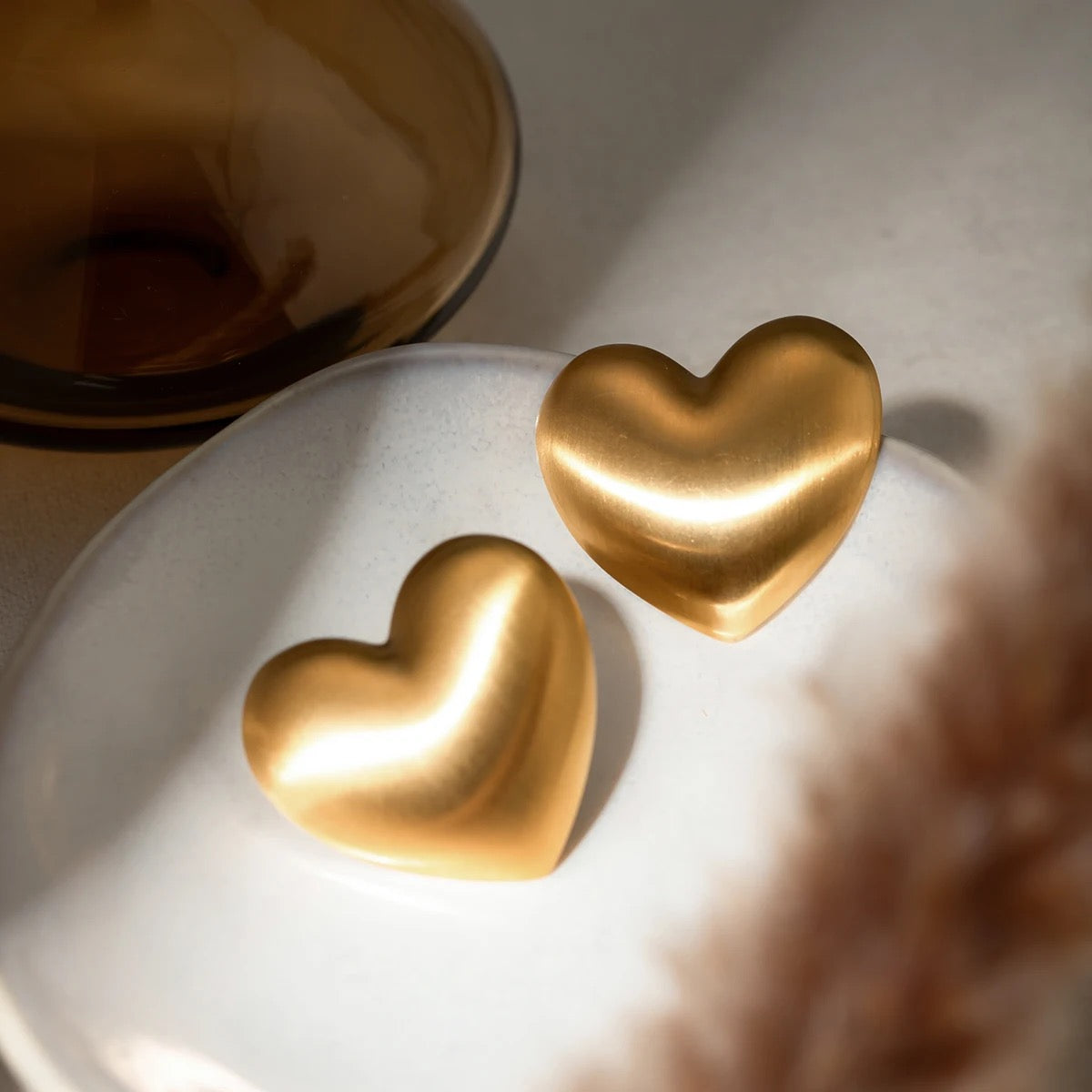 Vintage gold heart shaped earrings handcrafted in stainless steel with brushed finish, by Lucky 13 jewelry.