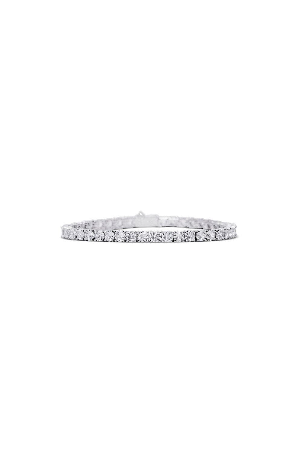 The CRYSTAL CLEAR BRACELET by LUCKY13 is a delicate and classic piece that features a continuous line of sparkling round-cut cubic zirconia stones set in a thin band with 14K Gold plating. This elegant and sophisticated bracelet is beautifully displayed against a white background.