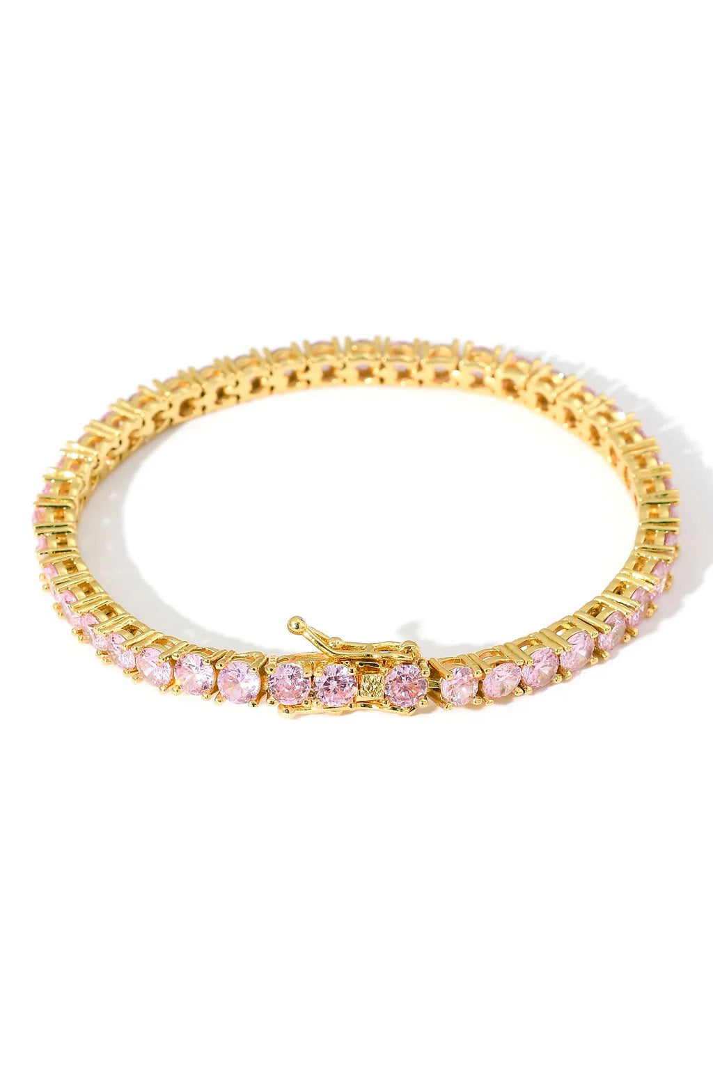 Pink crystal tennis bracelet. This classic riviera features 18cm of round-cut pink cubic zirconia stones and a lobster clap closure. Handcrafted by Lucky13 jewelry.