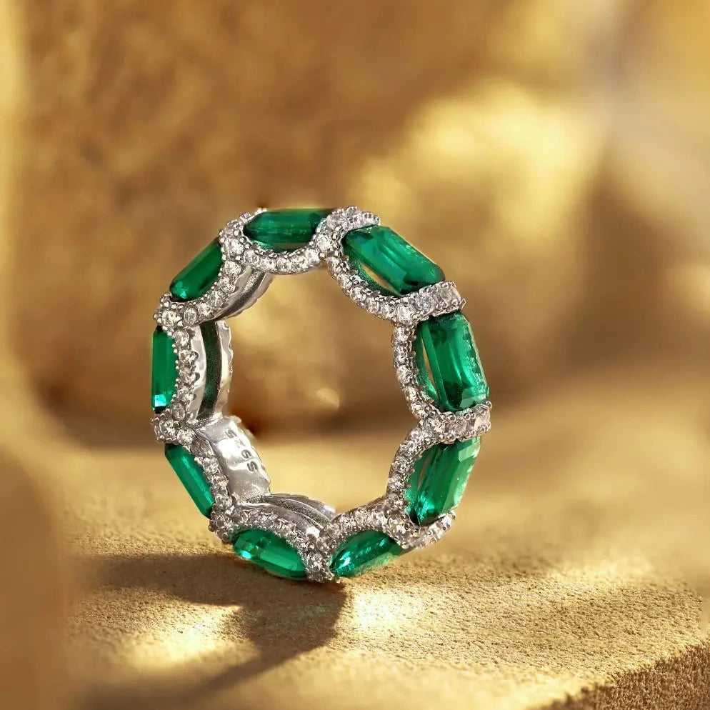 eternity ring, handcrafted in 925 sterling silver set with sparkling green cubic zirconia stones.